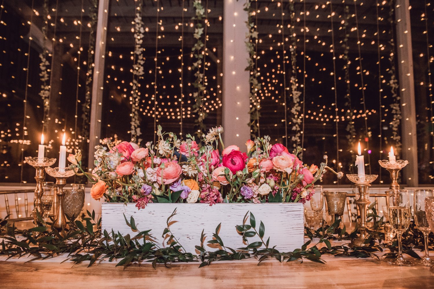 an incredible display of candles and flowers on top of a table