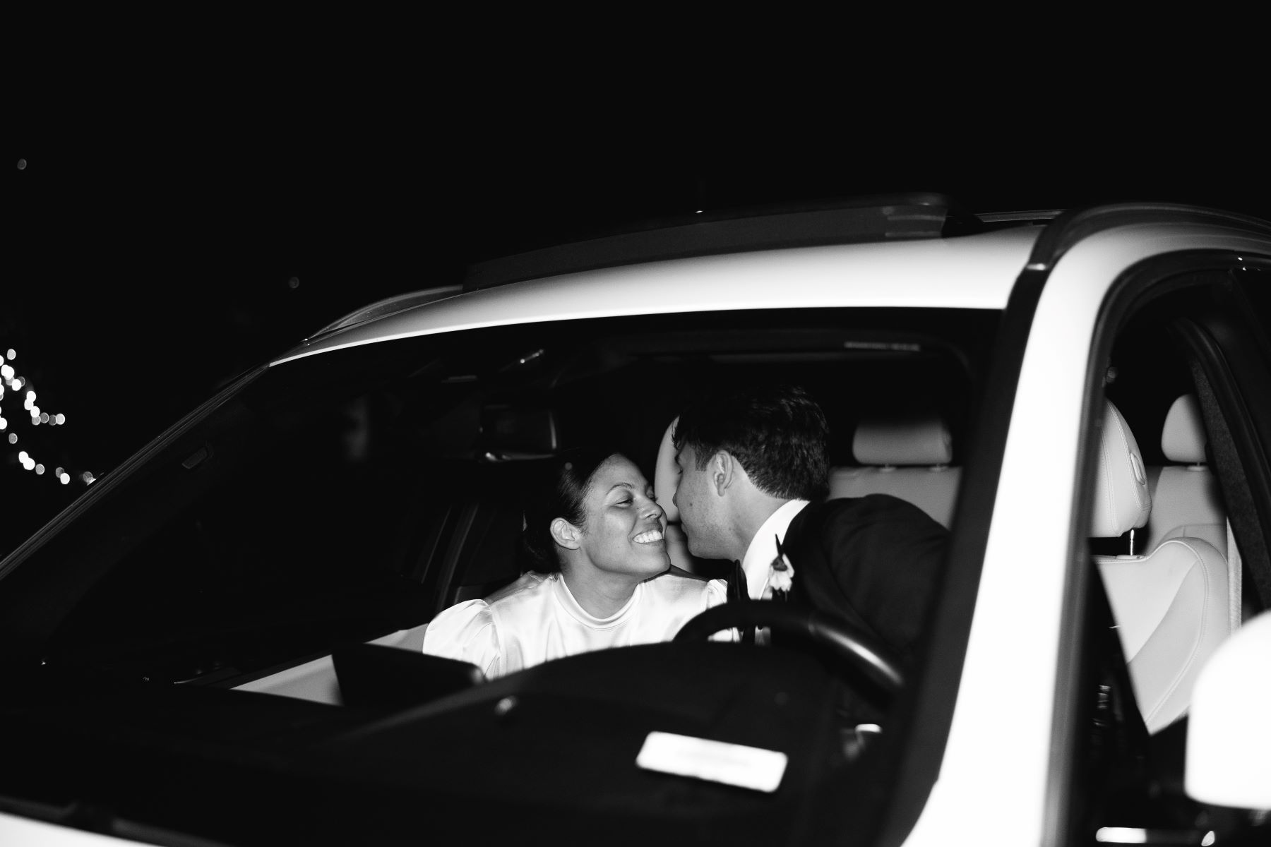 smiling bridesmaids are outside and holding flowers
