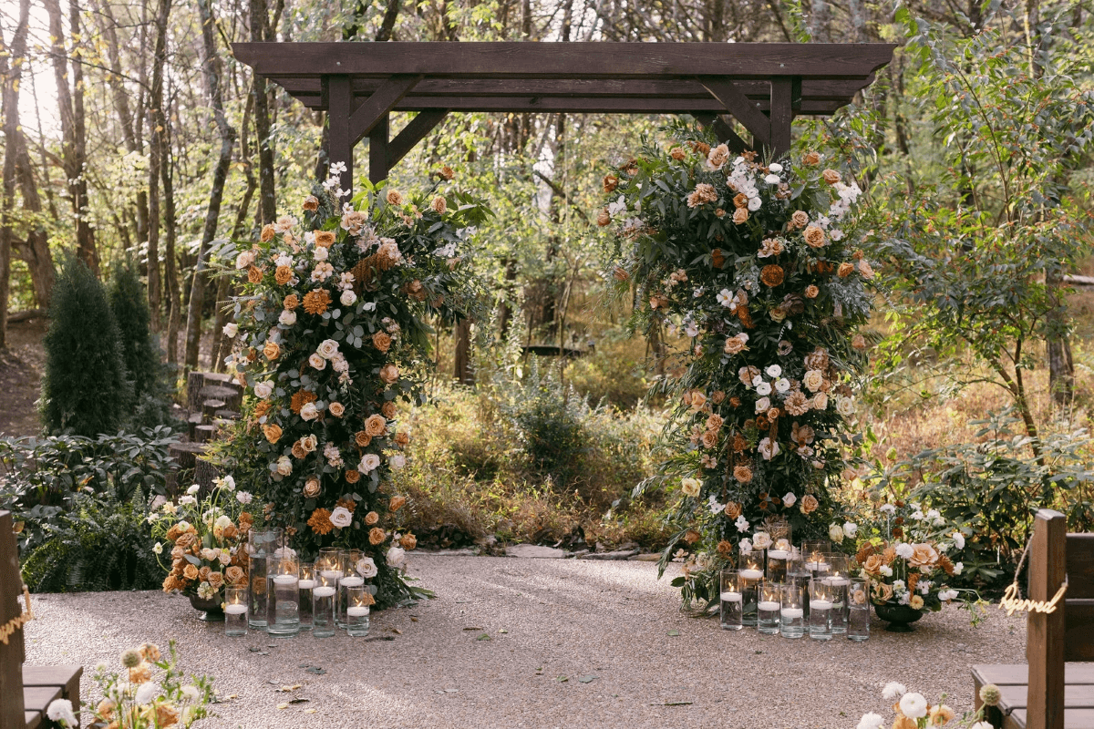 outside wedding arch covered in flowers